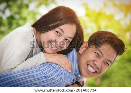 Portrait of a happy asia couple laughing at camera