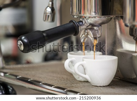 prepares espresso in his coffee shop