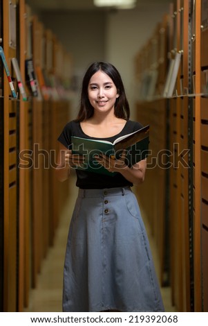 A portrait of a mixed race college asia student at campus in library