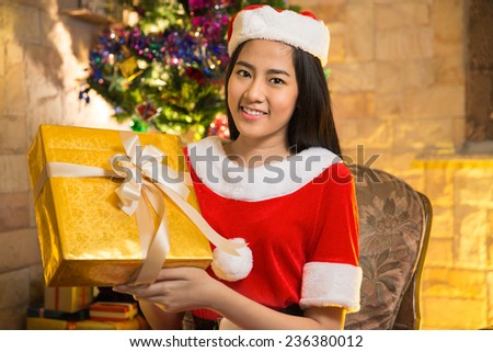 Beautiful Asia woman wear Santa Clause costume, christmas girl happy smile hold new year gift box present, in isolated on white background