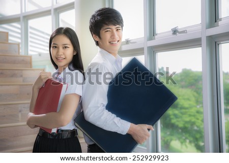 Asia students read a book in Library with uniform