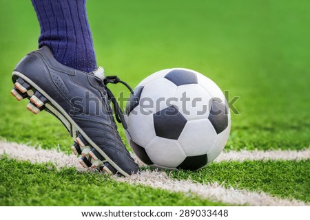 Shoot a soccer ball with his feet on the football field