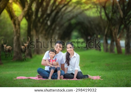 Asian family, Happy asian mother, father and daughter relax in the park