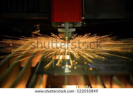 Cutting of sheet metal process with safety glass protection. Sparks fly from laser by automatic cutting CNC, PLC machine. fabricate work, factory, production