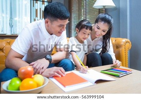 Father and Mather teach and relax with they Daughter  to do home work by draw and paint, family , kid , education concept.
