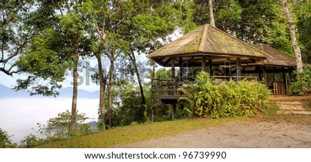 Pavilion and mist on hill side and green nature. at kangkrajan, Thailand.