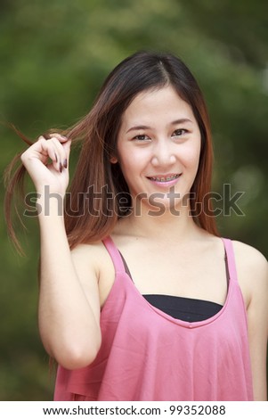 Young long hair Asia women action in a park.