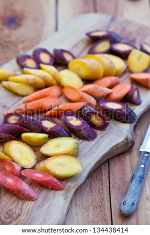Different kinds of carrot cut on wooden board. Also available in horizontal format.