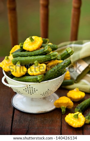 Baby Zucchini and Patty Pan Squash in white colander. Also available in horizontal format.