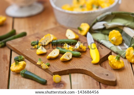 Baby Zucchini and Patty Pan Squash cut on wooden board. Also available in vertical format.