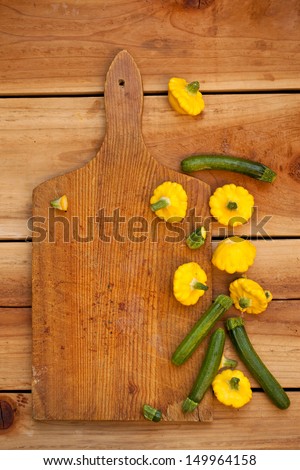 Baby Zucchini and Patty Pan Squash on wooden board.