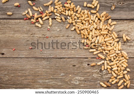 Peanuts in shells on wood background. Copy space. Also available in vertical format.