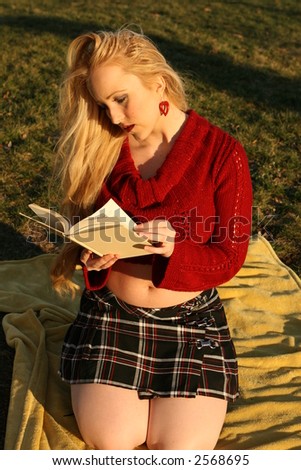 blonde model woman reading book outside