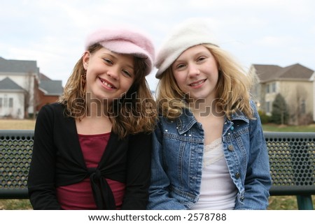young girl friends smiling at park