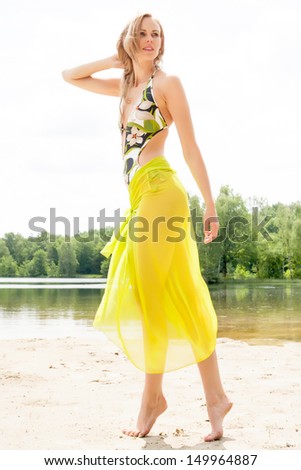 Beautifull model in bikini on the beach with sunny weather
