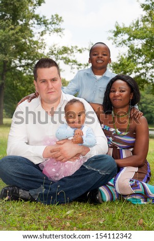 Happy mixed family is having a nice day in the park