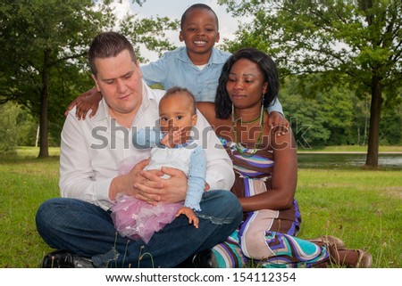 Happy mixed family is having a nice day in the park