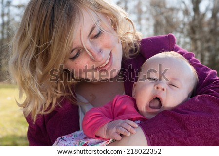 Young mother is having some nice time with her baby on a sunny day