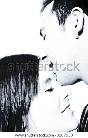 Boy kissing his girlfriend on the forehead