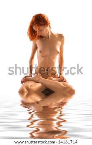 stock photo Portrait of a naked model with bright red hair in a lotus sit