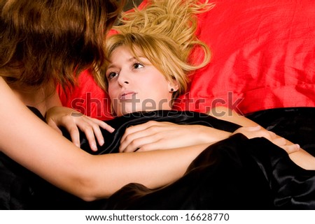 stock photo Two young lesbian girls relaxing in a bed