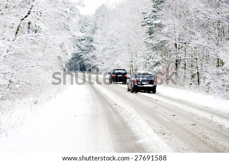 Belgium in winter, cars driving over a snow covered street