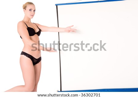 Lingerie model standing next to a white projector screen. Ideal for using as copy space for your message and others.