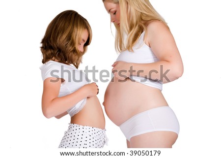 Girl comparing her belly size with the belly of her pregnant aunt.  Made in a studio environment on white background