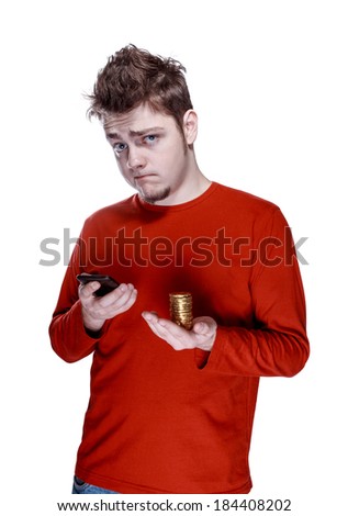 Portrait of emotional young guy with smartphone in one hand & golden coins in other