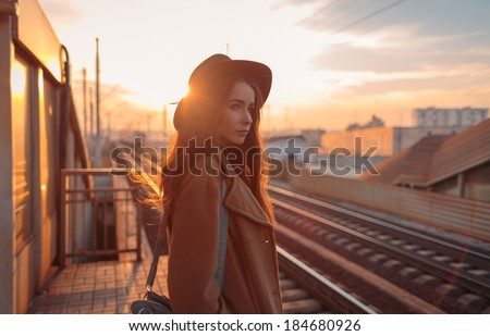 Portrait of beautiful young woman on railway platform
