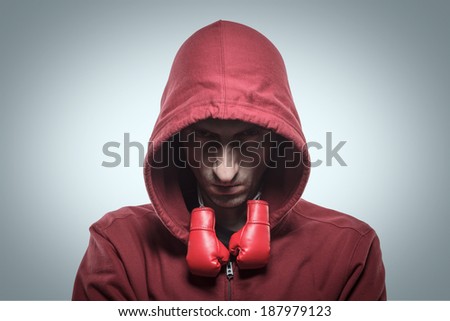man in the hood with small boxer gloves on his neck