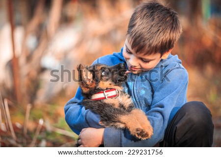 Boy with german shepherd dog puppy.