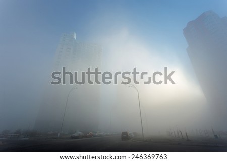sunlight through the fog on the morning city street