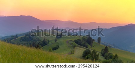 Wide panorama of mountains in sunset rays. Carpathian mountains. Ukraine.