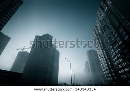 Urban perspectives. Morning fog on the modern city street.