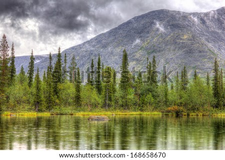 mountain landscape with lake, forest and clouds, rainy weather, HDR image(High Dynamic Range), Kola Peninsula, Khibiny mountains, Russia, 2014