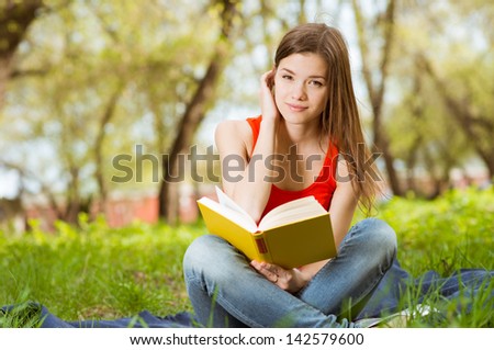 pretty girl read book in park