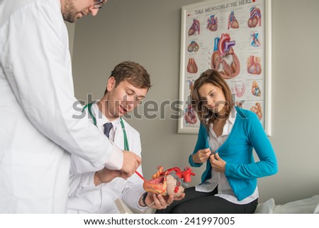 two doctors consult patient with heart problems