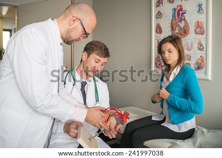two doctors consult patient with heart problems