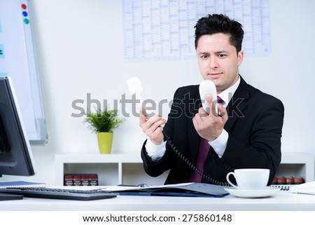 attractive business man overloaded at work in office