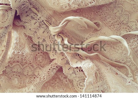 Lace: detail of a beige vintage clothing.