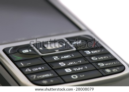 Close up of mobile phone keypad illuminated isolated by white
