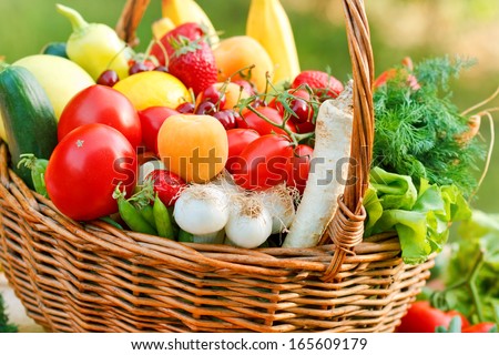 Wicker basket is full of fresh, organic fruits and vegetables