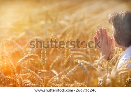 Woman pray for a rich harvest