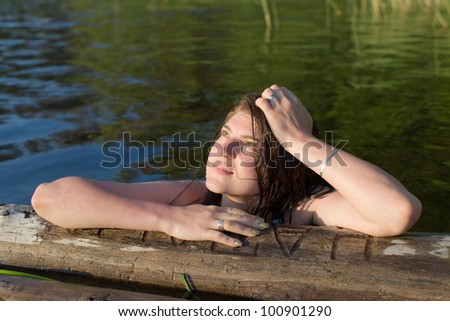 portrait of the girl in water of the summer lake
