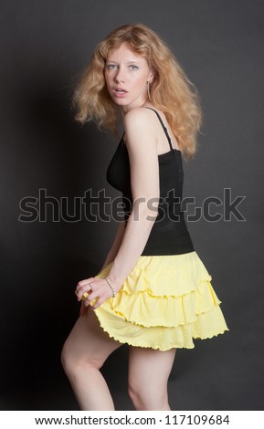 the sensual girl in a yellow skirt