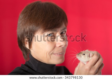 woman with pet rat on a red background
