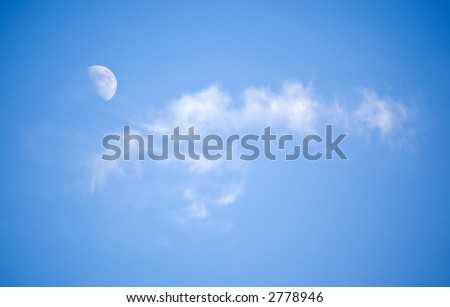 The moon and lonely cloud in clear winter day