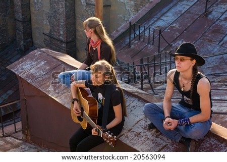 Two girls and the guy on a roof