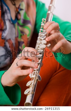 Hands of the girl playing a flute